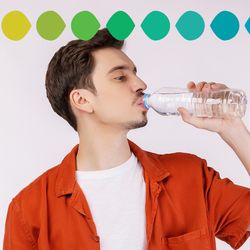 man wearing orange shirt and drinking from a bottle of water, along the top and bottom of the image is a rainbow of coloured droplets to represent a pH scale