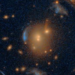 The lens has a strong circular symmetry. at the center there are three galaxies and the warped, usually thin, images of the lensed galaxies are found on curves symmetric to the center