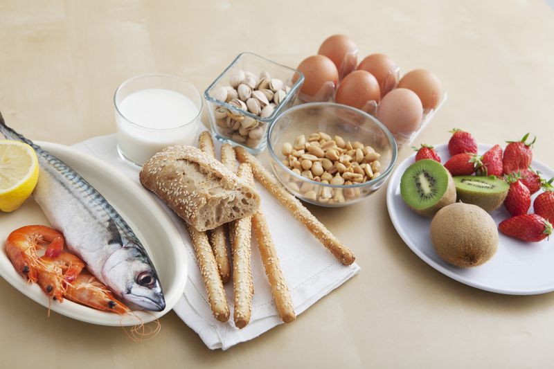 Fish, bread, milk, peanuts, eggs, kiwi, and strawberries 