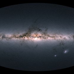 a map of the milky way that looks like a photo. the galaxy is a thin strip of stars with wispy dark clouds 