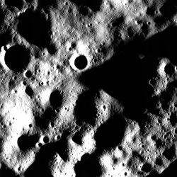 An heavily cratered area of the Moon with many of the craters in darkness but for the rim are visible in this photo