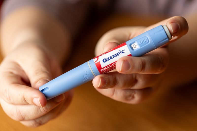 Person holding an injectable pen of Ozempic.