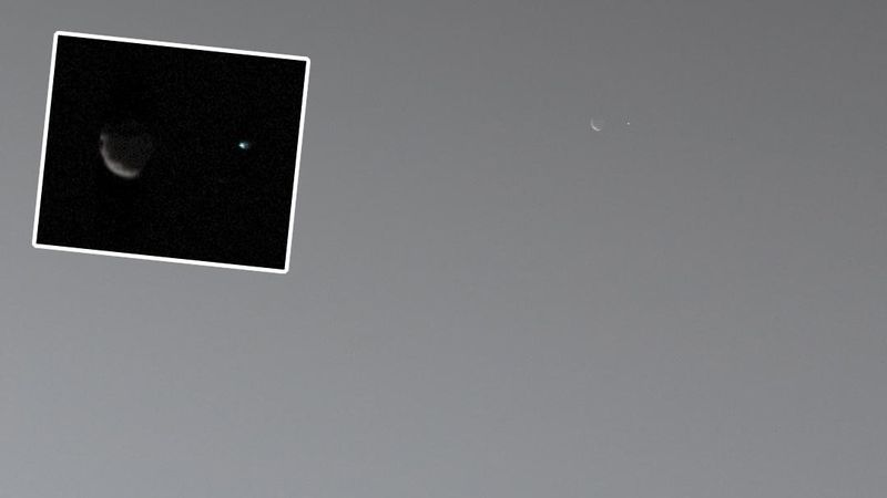 The image of phobos as a crescent with a dot next to it which is the Earth. A zoomed in inset show the same with more details of phobos showing its potato shape.