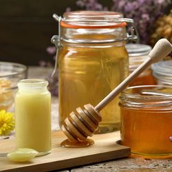 Jars of royal jelly and honey on a table