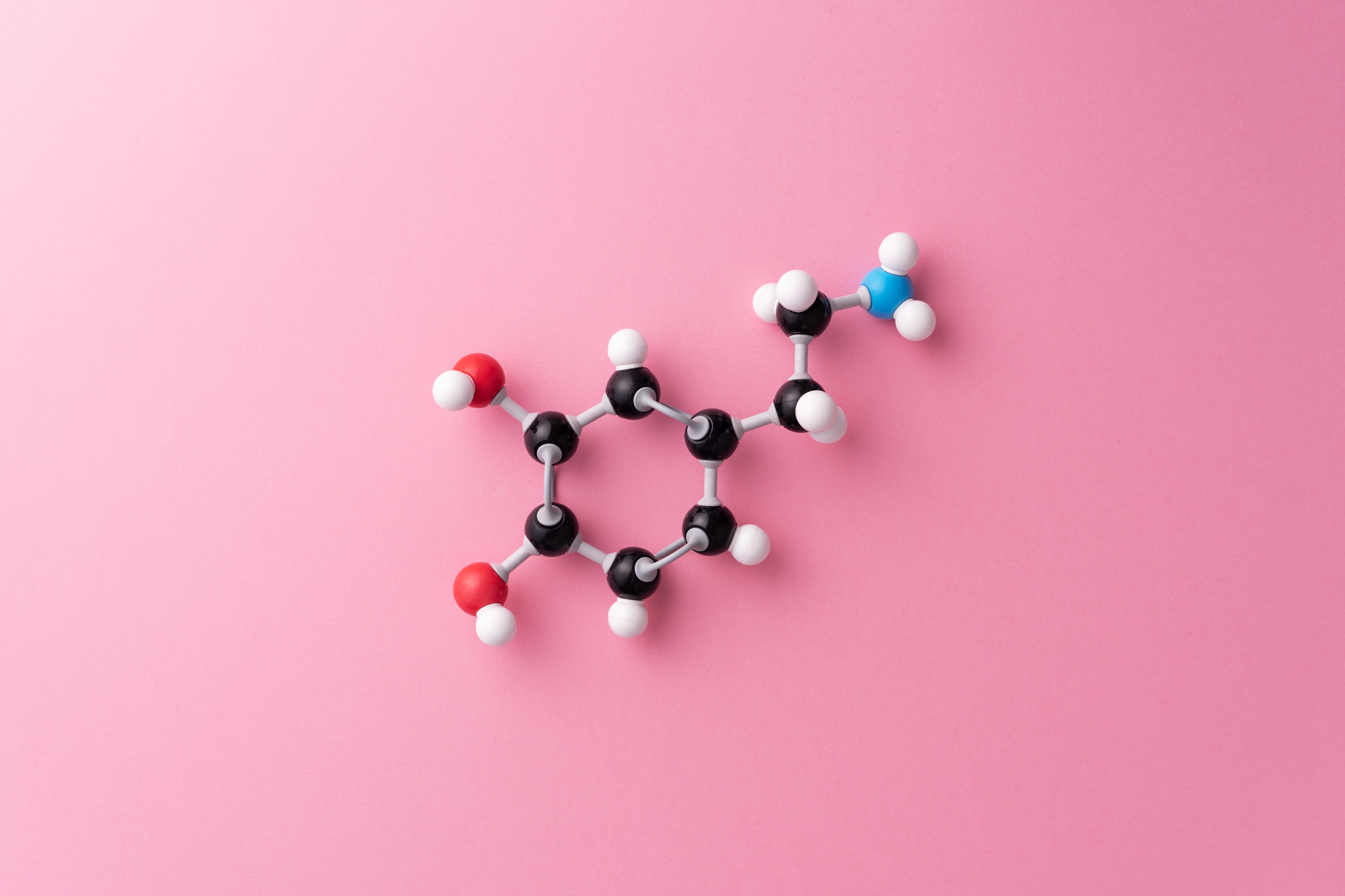 Dopamine chemical formula over pink background