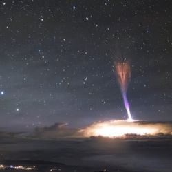 A red sprite and blue jet seen on top of a thunderstorm captured near Mauna Kea in Hawaii in 2017.