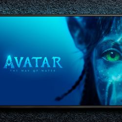 TV on black wall showing title card of Avatar the way of water alongside the face of a Na'vi