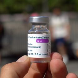 close up of someone holding a vial of the AstraZeneca covid-19 vaccine