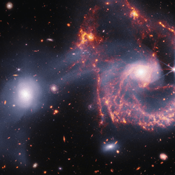 The image shows a large spiral galaxy whose main spiral arm is almost a semi circle, no other arms are present but wips of gas are extended around it, evidence of the merger. Next to it the elliptical galaxy mostly unaltered bu white gas extends from it to the spiral as well as creating a cone in the opposite direction.