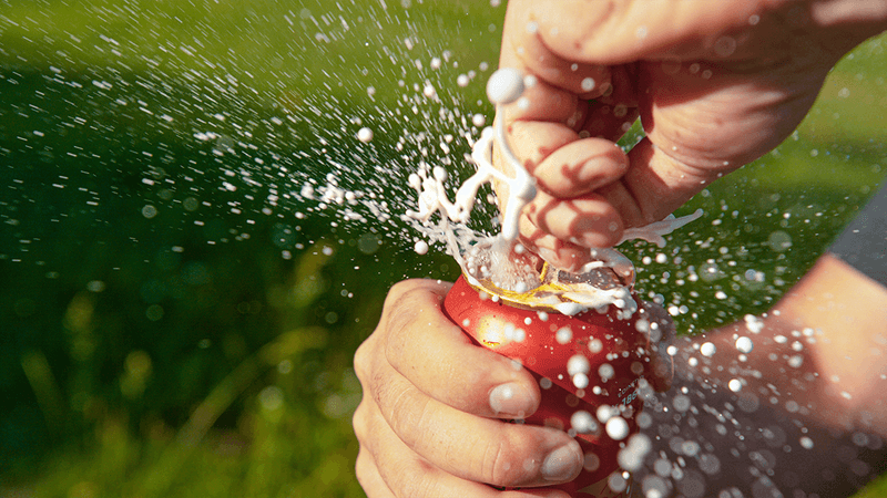 A can of coke fizzing upon opening.