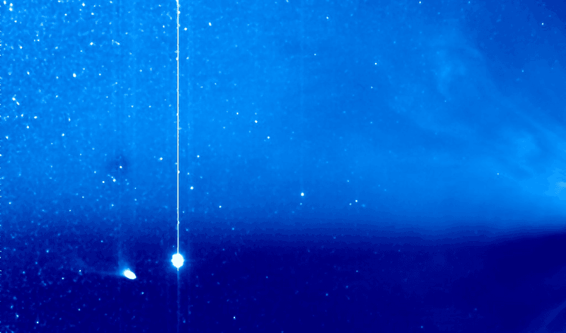 Comet Pons-Brooks (lower left) with its tail on the point of breaking off. Jupiter appears nearby, while the coronal mass ejection is swirling off the Sun, which is out of view to the right.