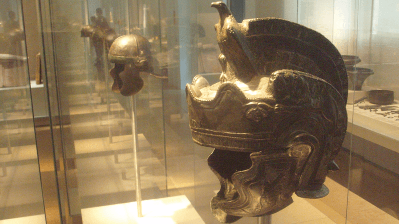 helmets of ancient rome gladiators on display in a museum