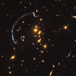 The strength of gravitational lenses like this one in Galaxy Cluster RCS2 032727-132623 are one of the things that make physicists confident dark matter exists, but could also be explained by a new theory.