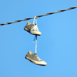 a pair of sneakers wrapped around a powerline