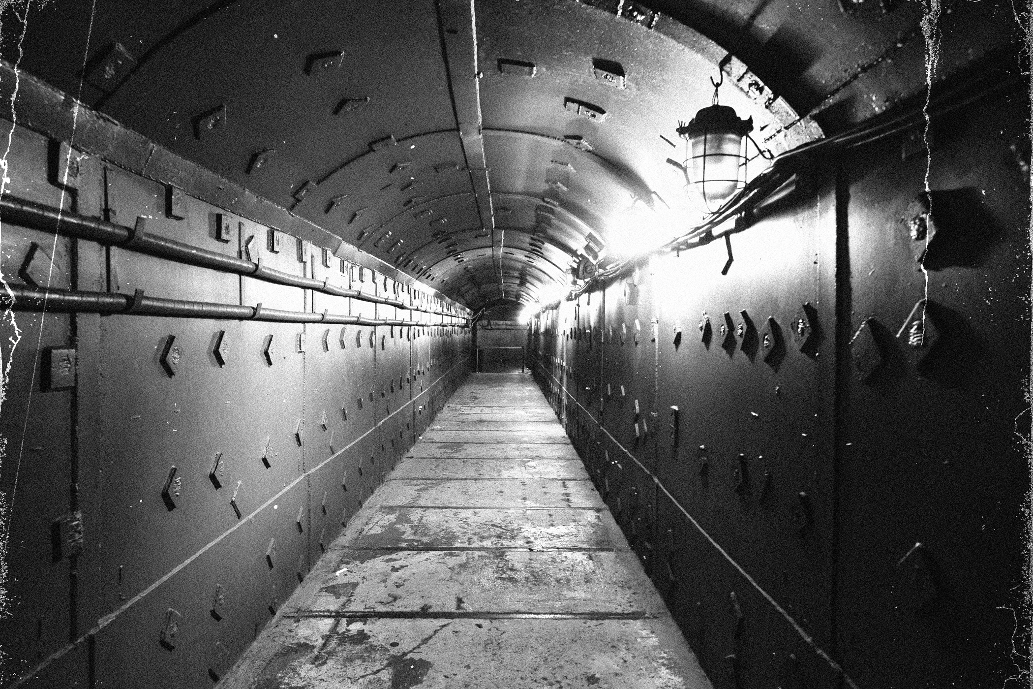 A black and white photo of an underground bunker illustrating the urban legend of the Russian Sleep Experiment