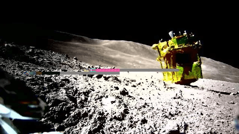 The lunar surface is grey with many jagged rocks. The spacecraft is golden and on its side with the retrorocket point up.