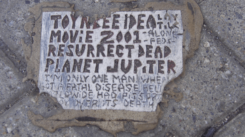 one of the toynbee tiles embedded in a street in the united states