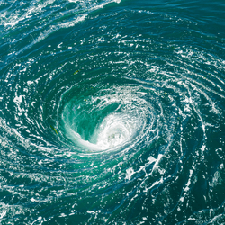 blue ocean water swirling into a whirlpool