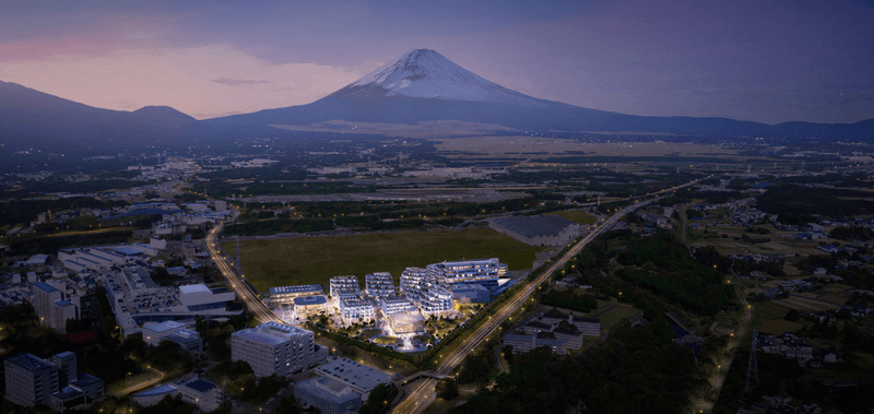 A computer-generated image of the Woven City concept with Mount Fuji in the background.